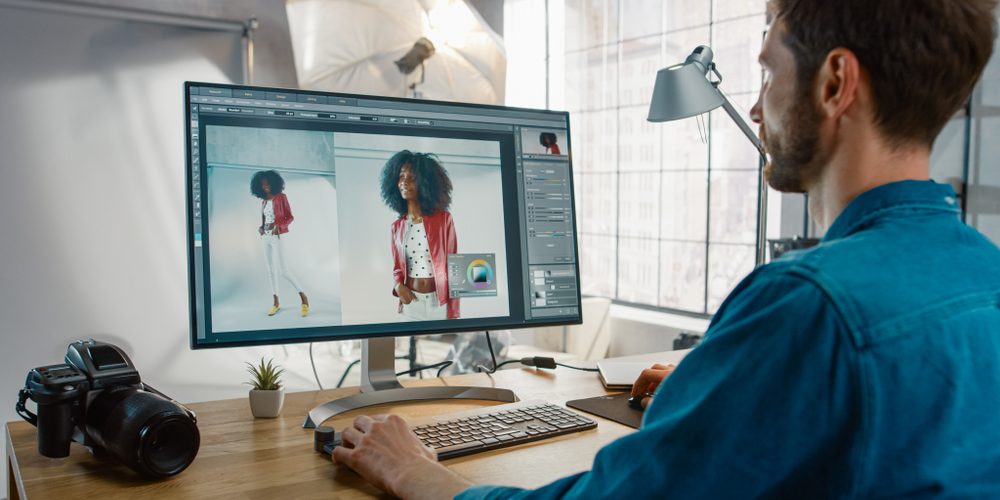 Professional,Photographer,Sitting,At,His,Desk,Uses,Desktop,Computer,In